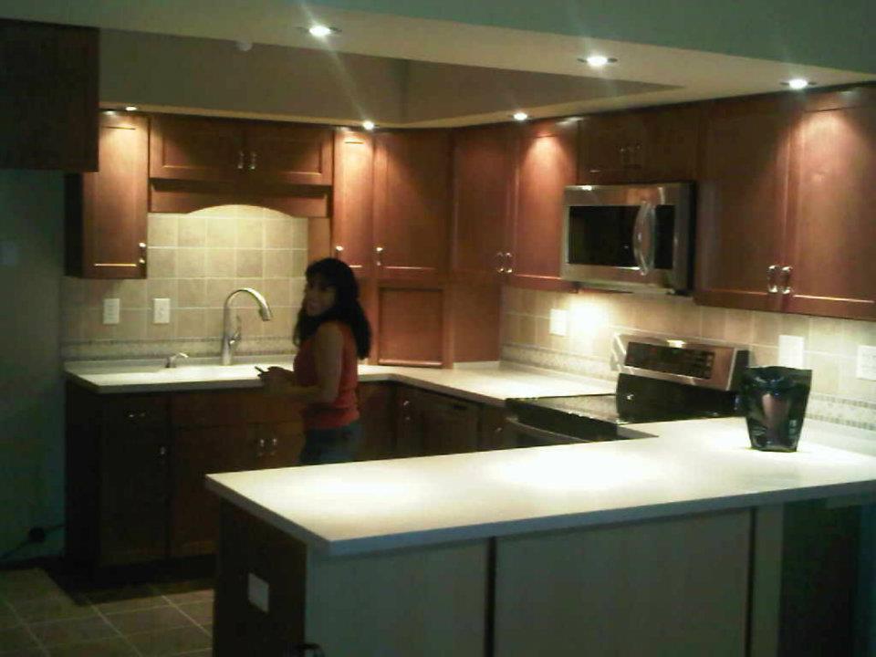 Woman in newly renovated kitchen.